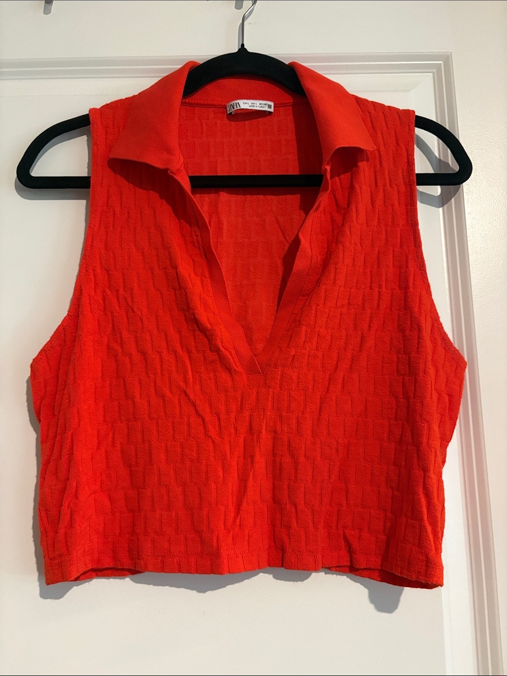 Zara sleeveless tank with a deep V polo collar